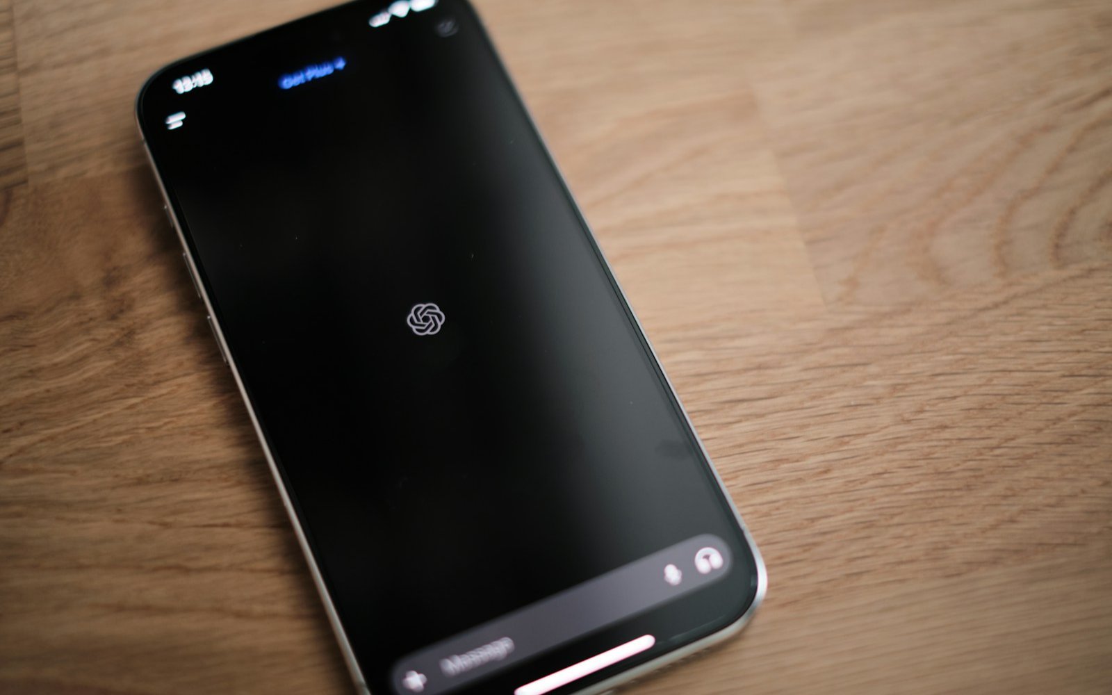 A phone lying on a wooden table