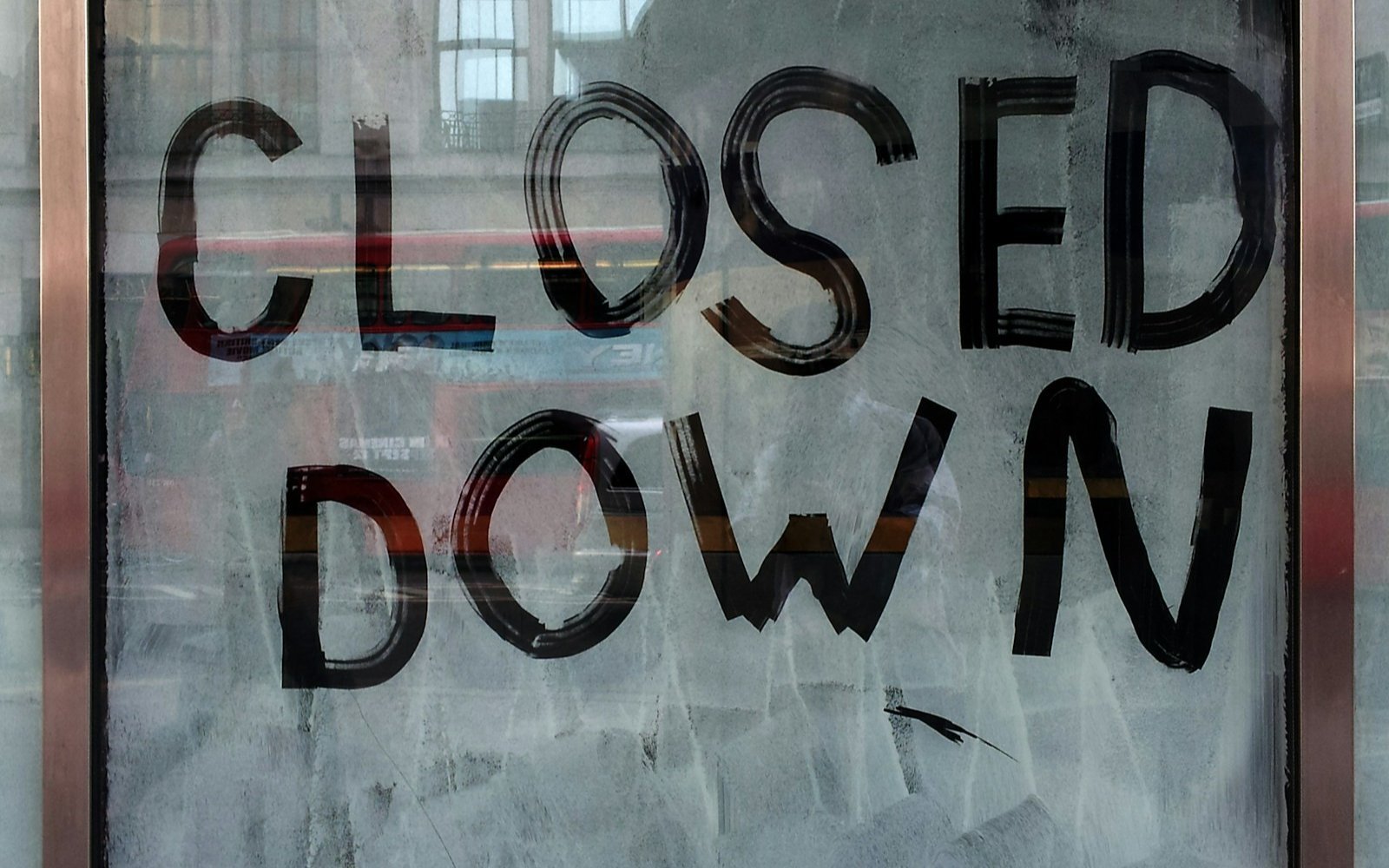 A shop window printed with a closed down notice