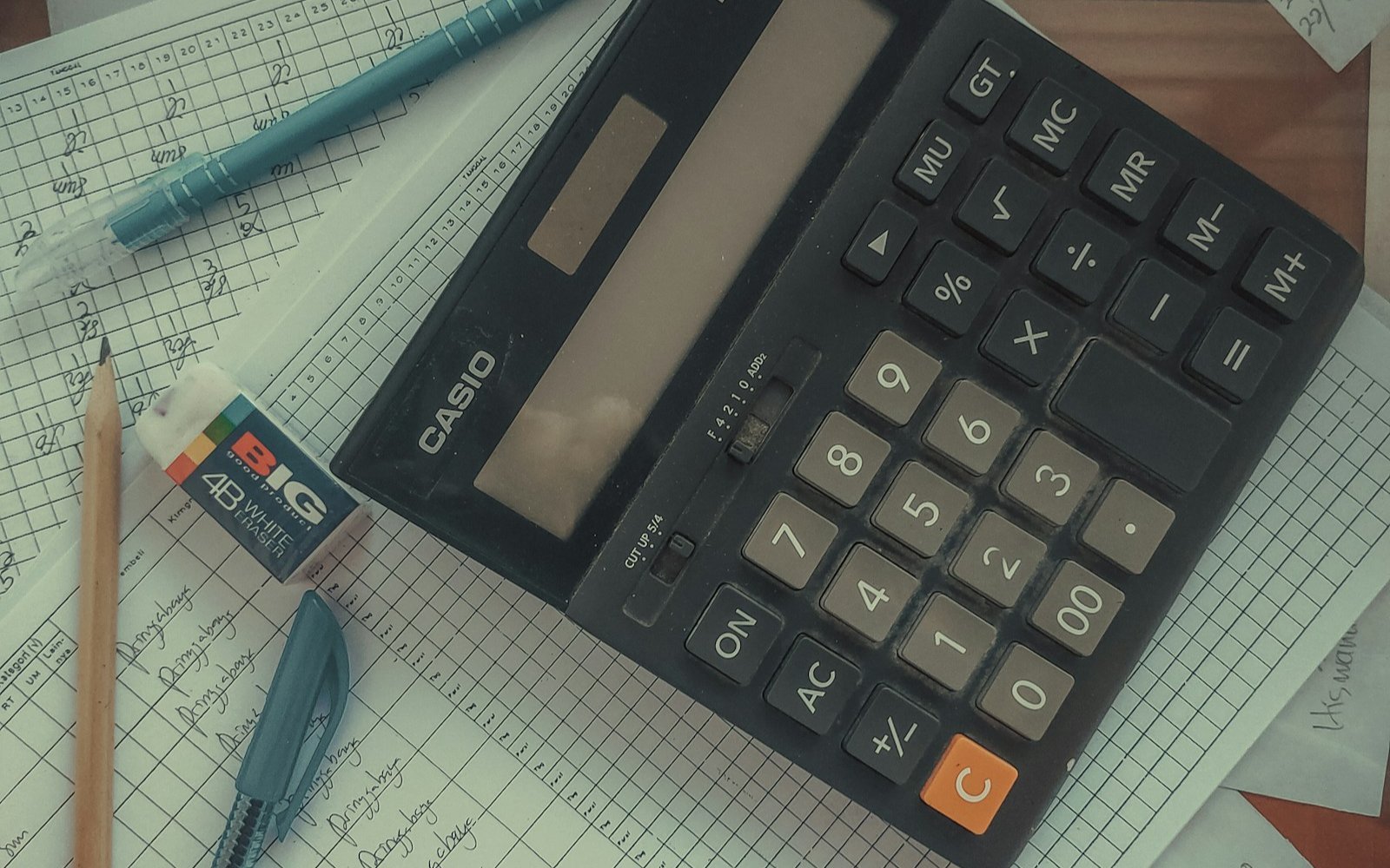 A calculator resting on a pile of paperwork