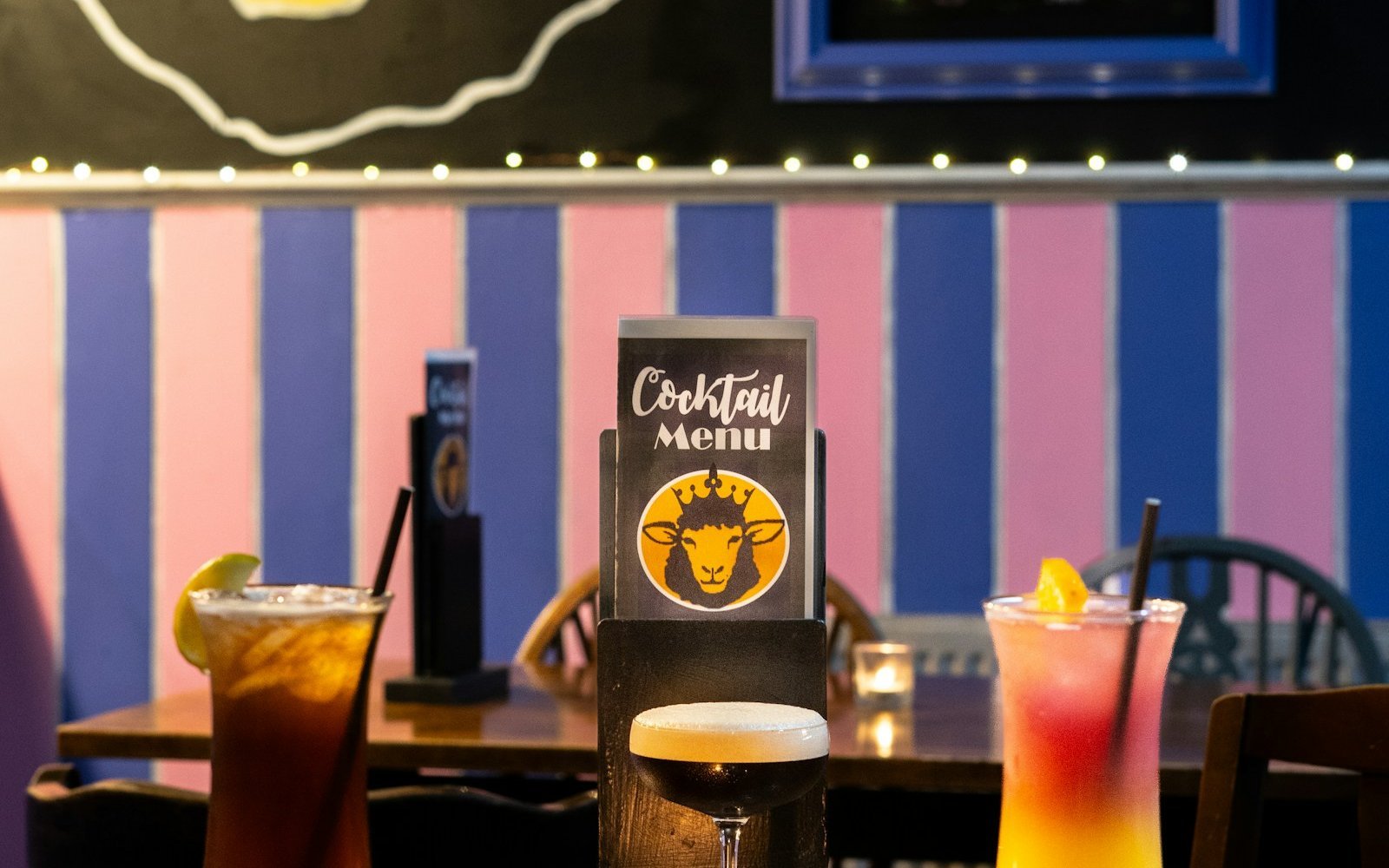 Two drinks and a menu on a pub table