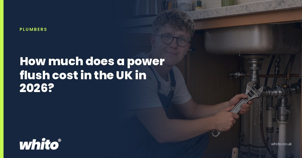 Whito founder pictured as a plumber kneeling under a kitchen sink with an adjustable spanner, on a navy Whito card headed “How much does a power flush cost in the UK in 2026?”.
